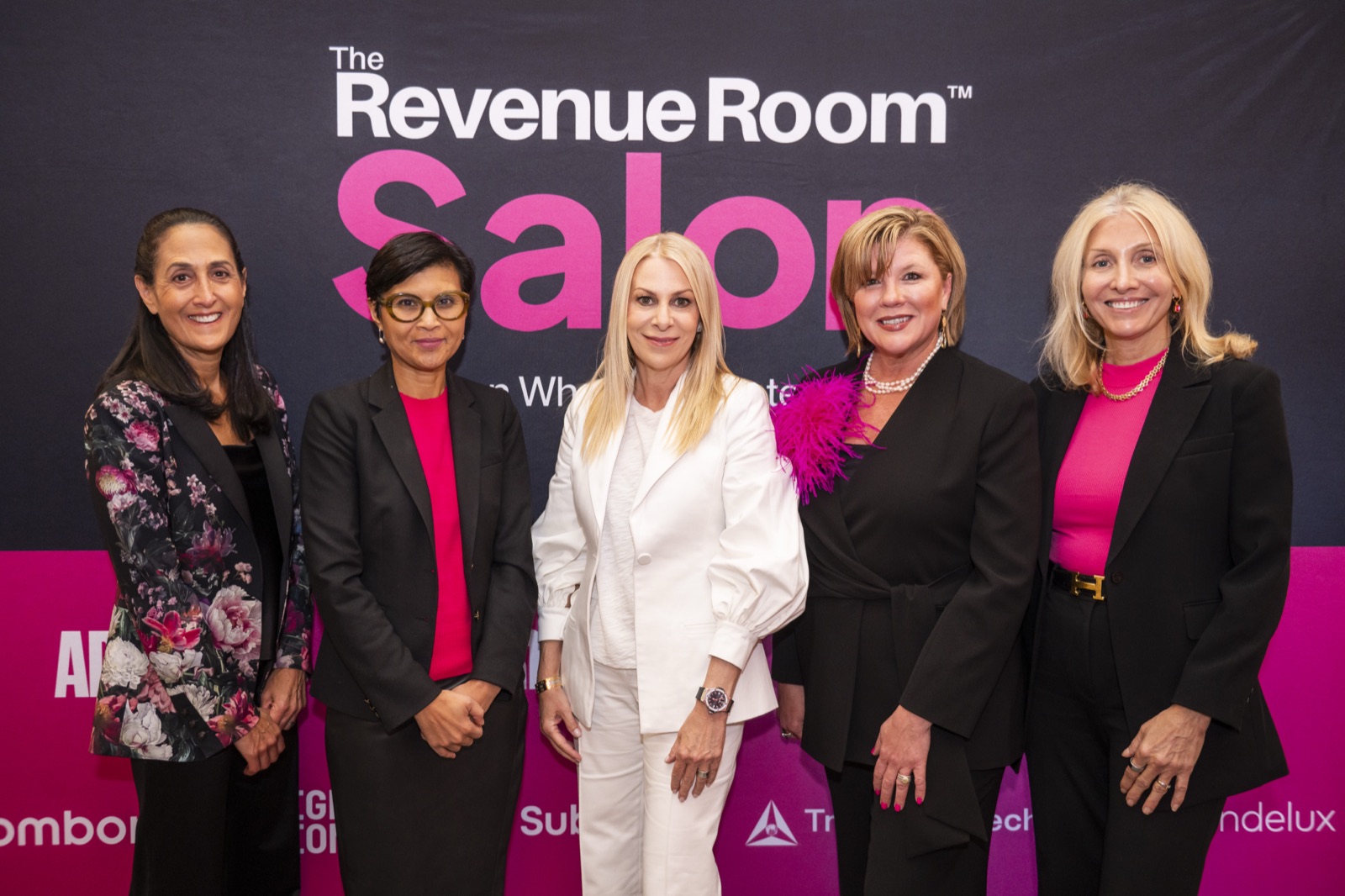 Speakers and hosts in front of the Revenue Room™ Salon backdrop